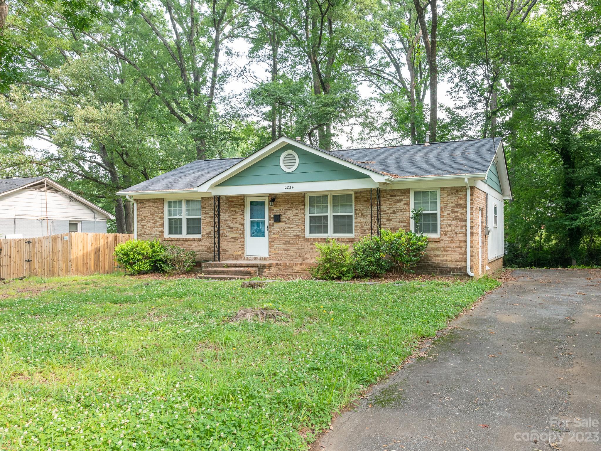 2824 Fordwood Drive Charlotte, NC 28208 - Photo 9 of 33 a front view of a house with a yard and porch