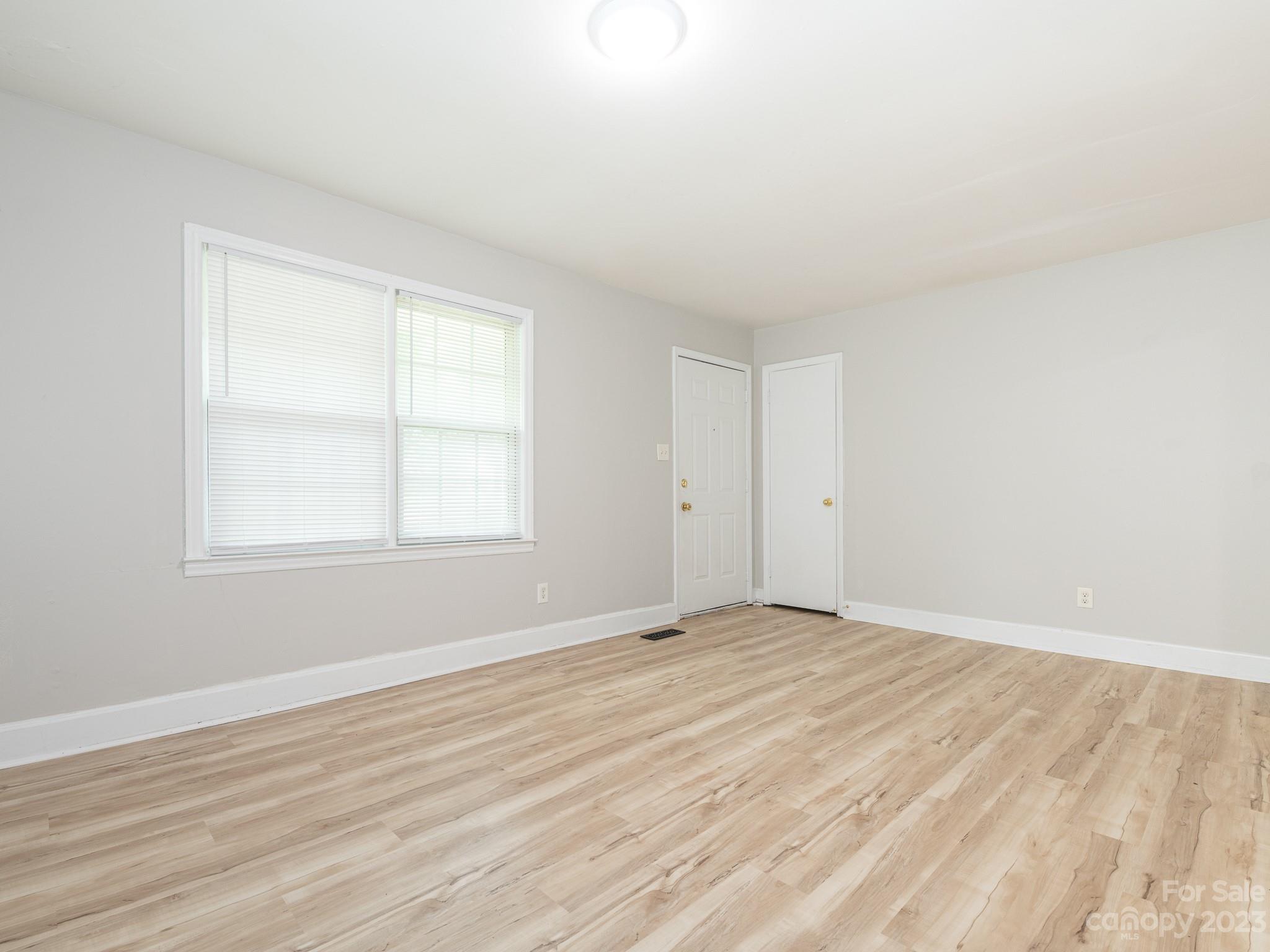 2824 Fordwood Drive Charlotte, NC 28208 - Photo 10 of 33 a view of an empty room with wooden floor and a window