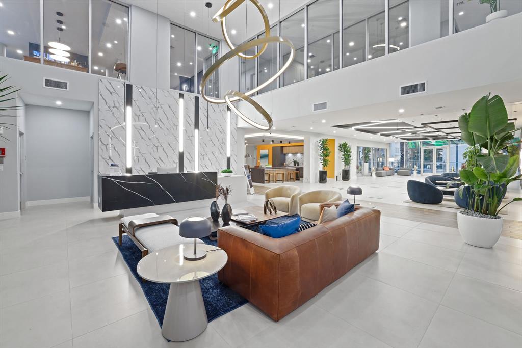 120 North Compass Way, Unit 230 Dania Beach, FL 33004 - Photo 1 of 42 a living room with furniture and a chandelier