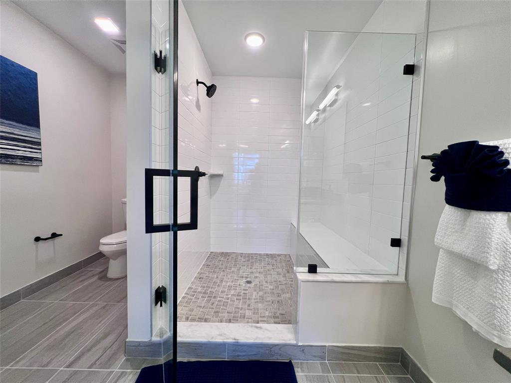 120 North Compass Way, Unit 230 Dania Beach, FL 33004 - Photo 13 of 42 a bathroom with a glass shower door a sink and a shower