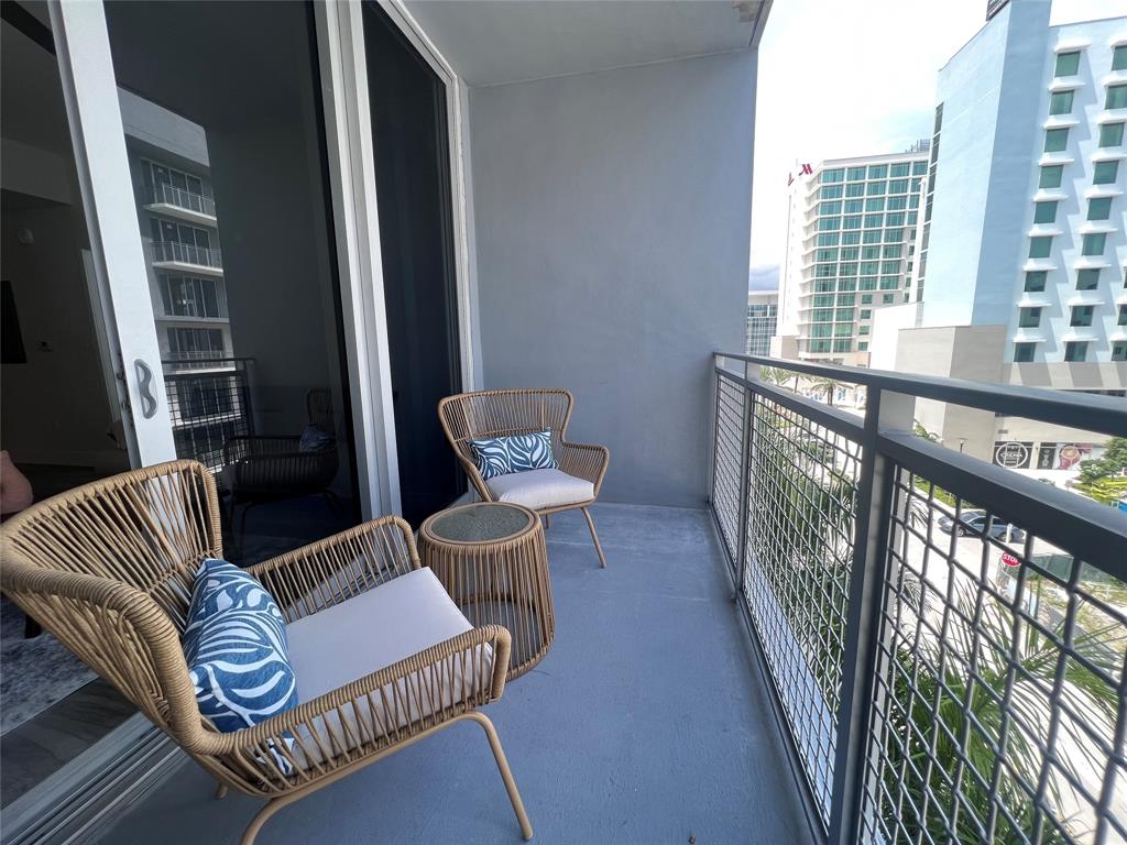 120 North Compass Way, Unit 230 Dania Beach, FL 33004 - Photo 14 of 42 a view of a balcony with furniture