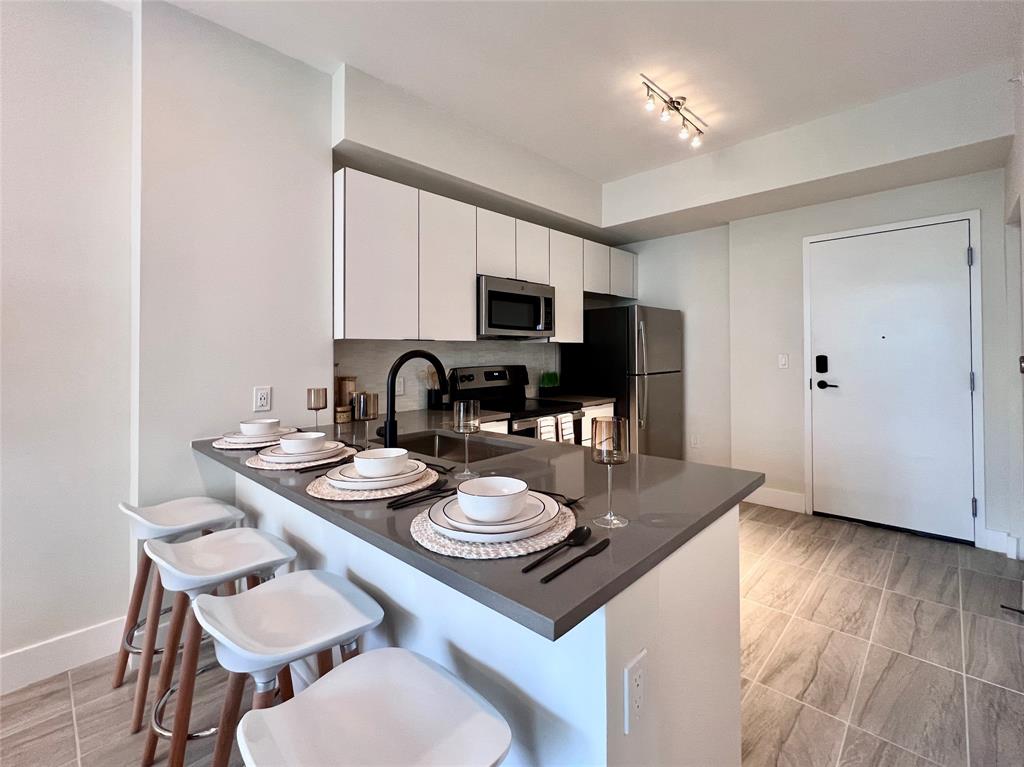 120 North Compass Way, Unit 230 Dania Beach, FL 33004 - Photo 2 of 42 a view of a dining room with furniture and wooden floor