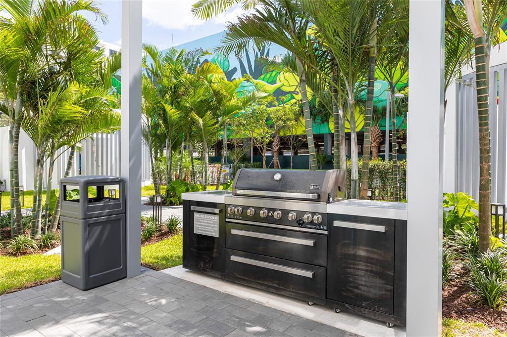 120 North Compass Way, Unit 230 Dania Beach, FL 33004 - Photo 25 of 42 a backyard of a house with barbeque oven and outdoor seating