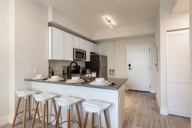 a kitchen with a sink cabinets and wooden floor