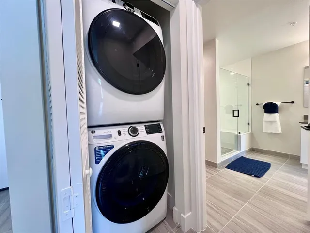a view of a hallway with washer and dryer