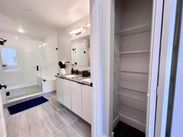 a large white kitchen with a refrigerator a sink and dishwasher