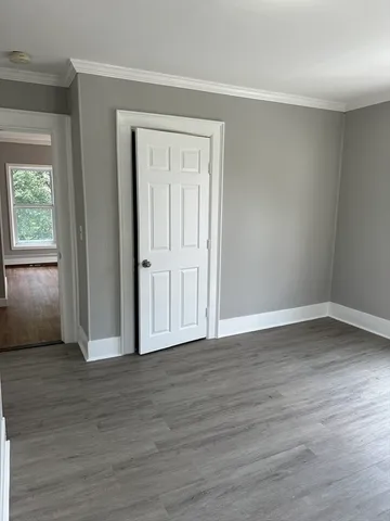 a view of wooden floor and windows in a room