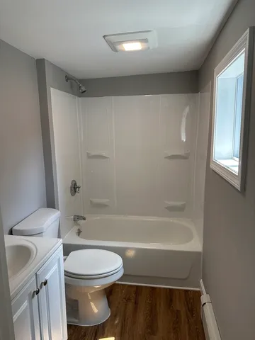 a bathroom with a toilet a sink and bathtub