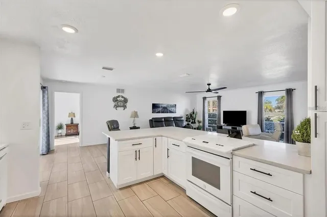 a kitchen with a sink stove top oven and cabinets