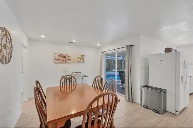 a dining room with furniture and a refrigerator