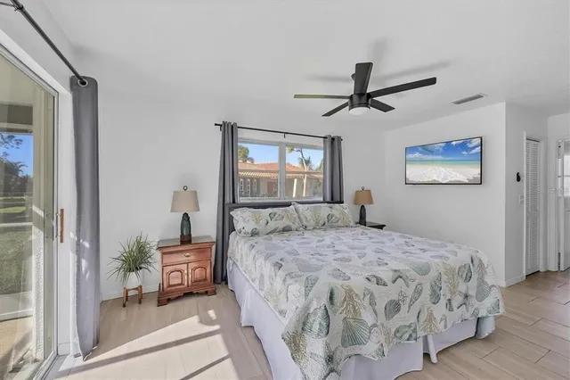 a bedroom with a large bed and a chandelier