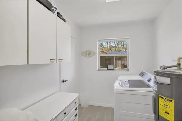 a utility room with closet dryer and washer