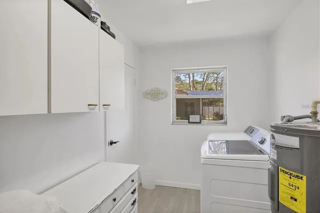 a utility room with closet dryer and washer