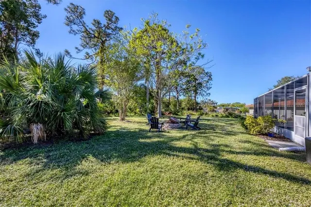 a view of a house with backyard sitting area and garden