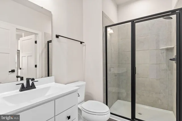 a bathroom with a sink mirror toilet and shower