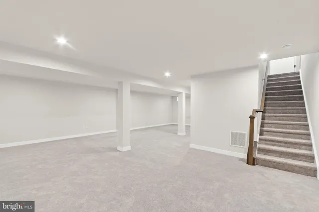 a view of an empty room with a staircase