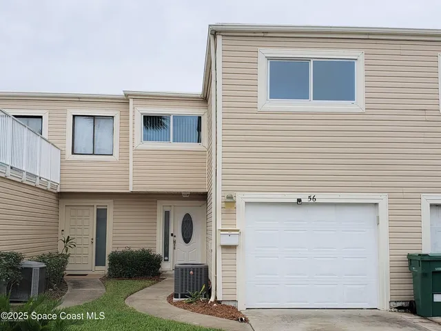 a front view of a house with garage