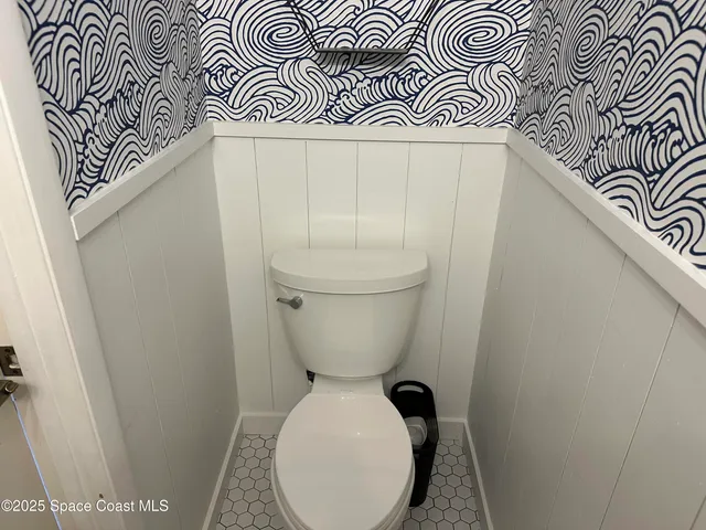 a view of a hallway with wooden floor and entryway