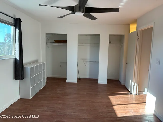 a view of a room with a wooden floor and a window