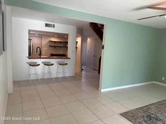 a view of kitchen with furniture and refrigerator