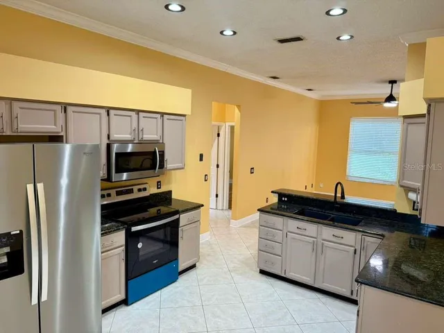 a kitchen with a refrigerator and a sink