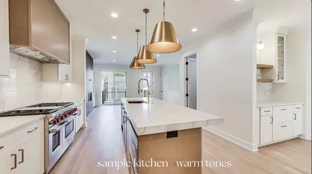 a kitchen with stainless steel appliances granite countertop a stove and a refrigerator