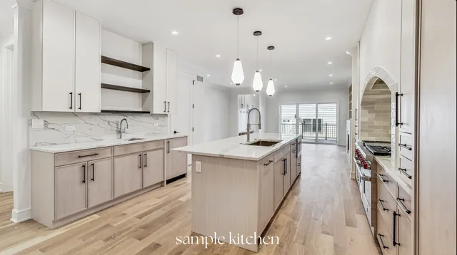 a kitchen with kitchen island granite countertop a sink a counter top space stainless steel appliances and cabinets