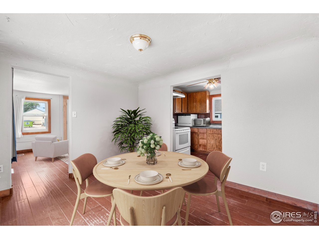 2706 7th Avenue Garden City, CO 80631 - Photo 13 of 47 a view of a dining room with furniture and wooden floor