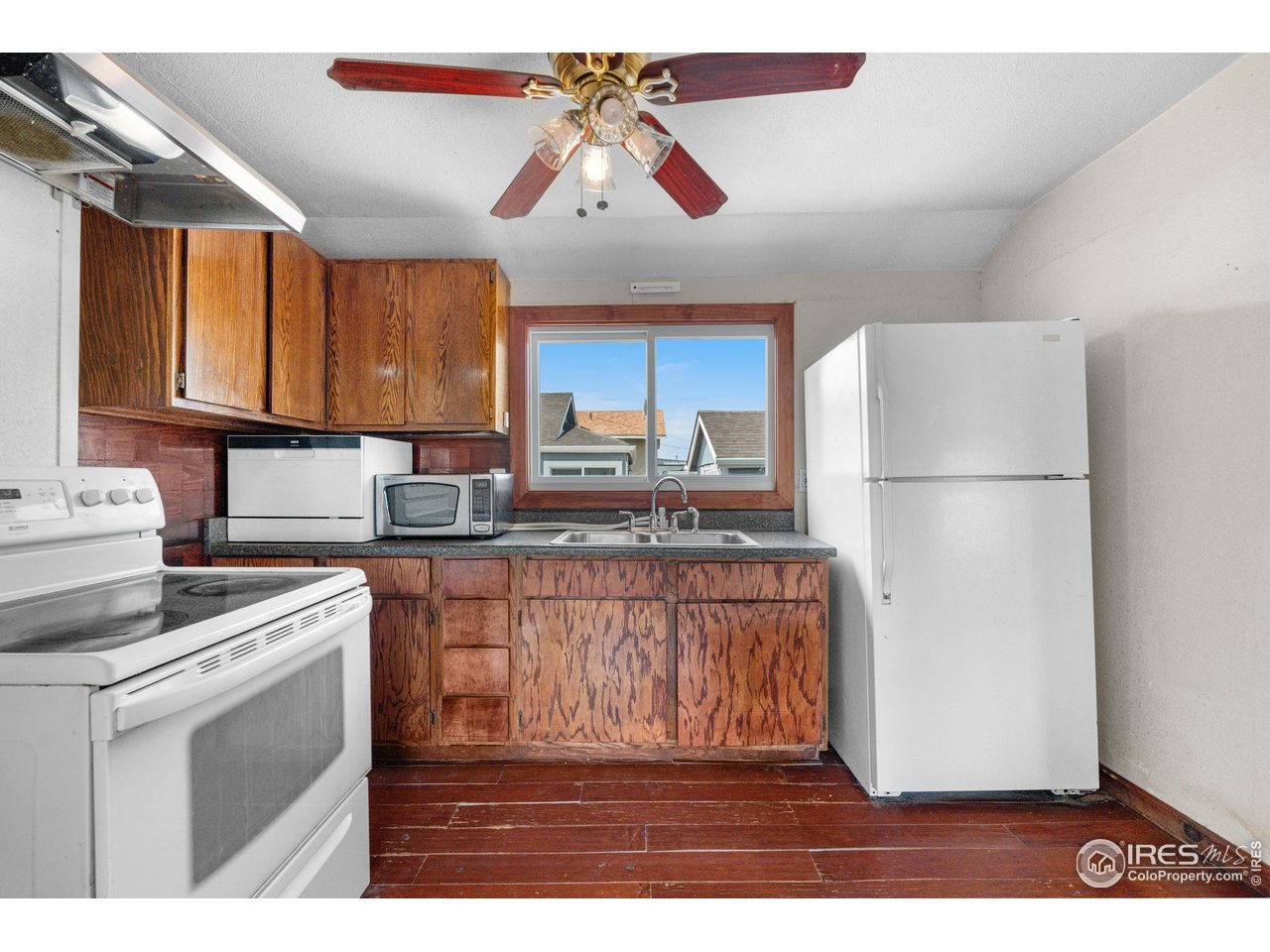 2706 7th Avenue Garden City, CO 80631 - Photo 15 of 47 a kitchen with stainless steel appliances granite countertop a refrigerator a stove a sink and a microwave