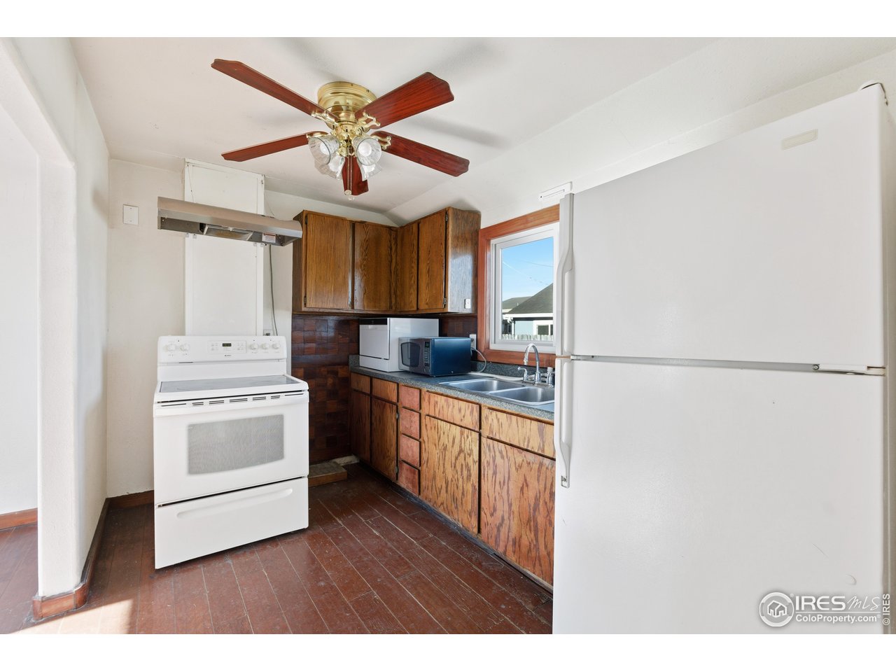 2706 7th Avenue Garden City, CO 80631 - Photo 16 of 47 a kitchen with a refrigerator a sink and dishwasher