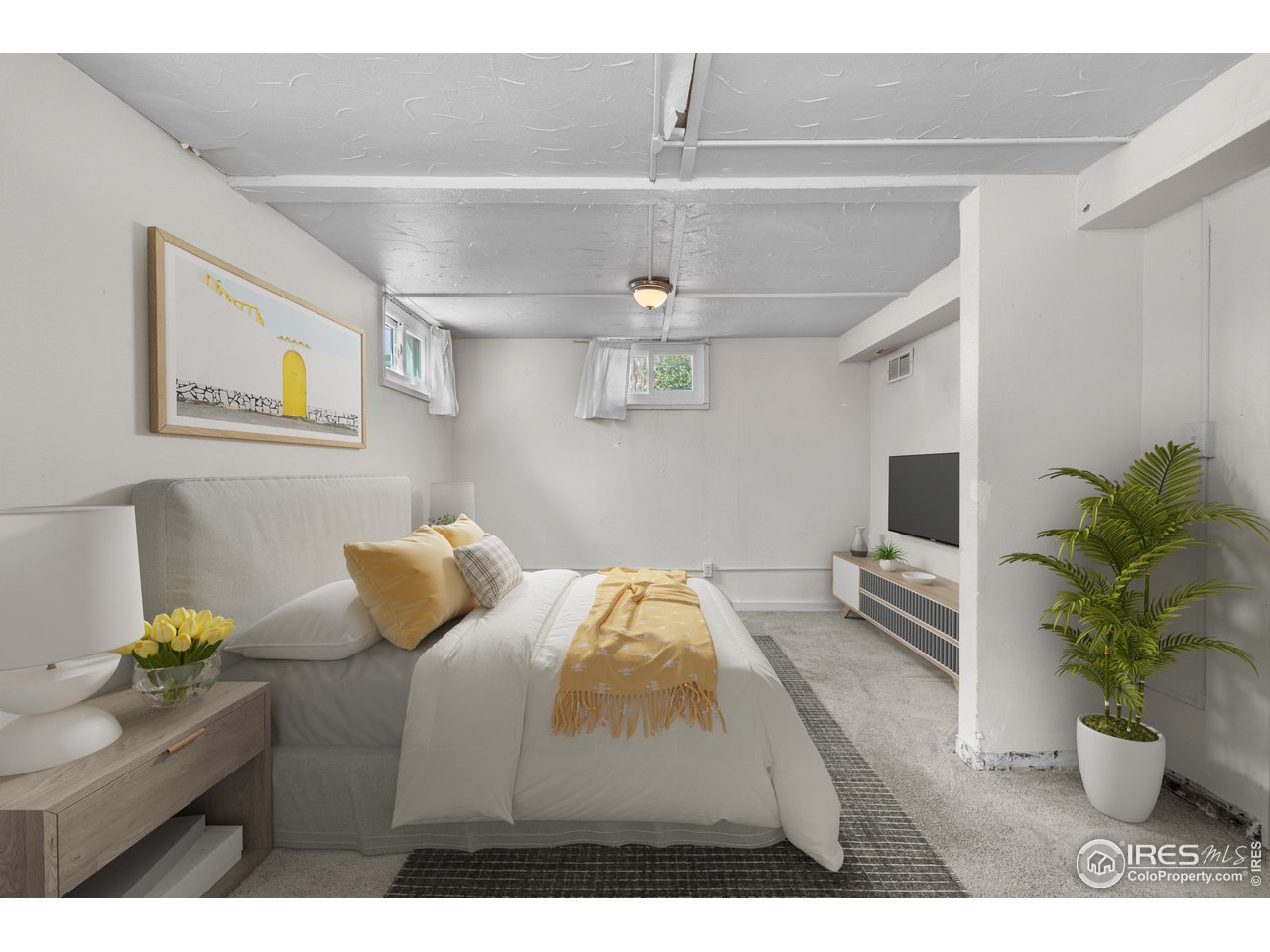 2706 7th Avenue Garden City, CO 80631 - Photo 25 of 47 a bedroom with furniture and a potted plant