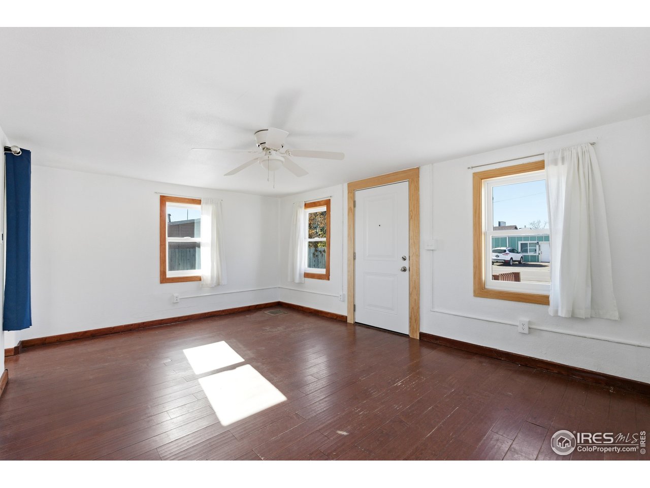 2706 7th Avenue Garden City, CO 80631 - Photo 4 of 47 wooden floor in an empty room with a window