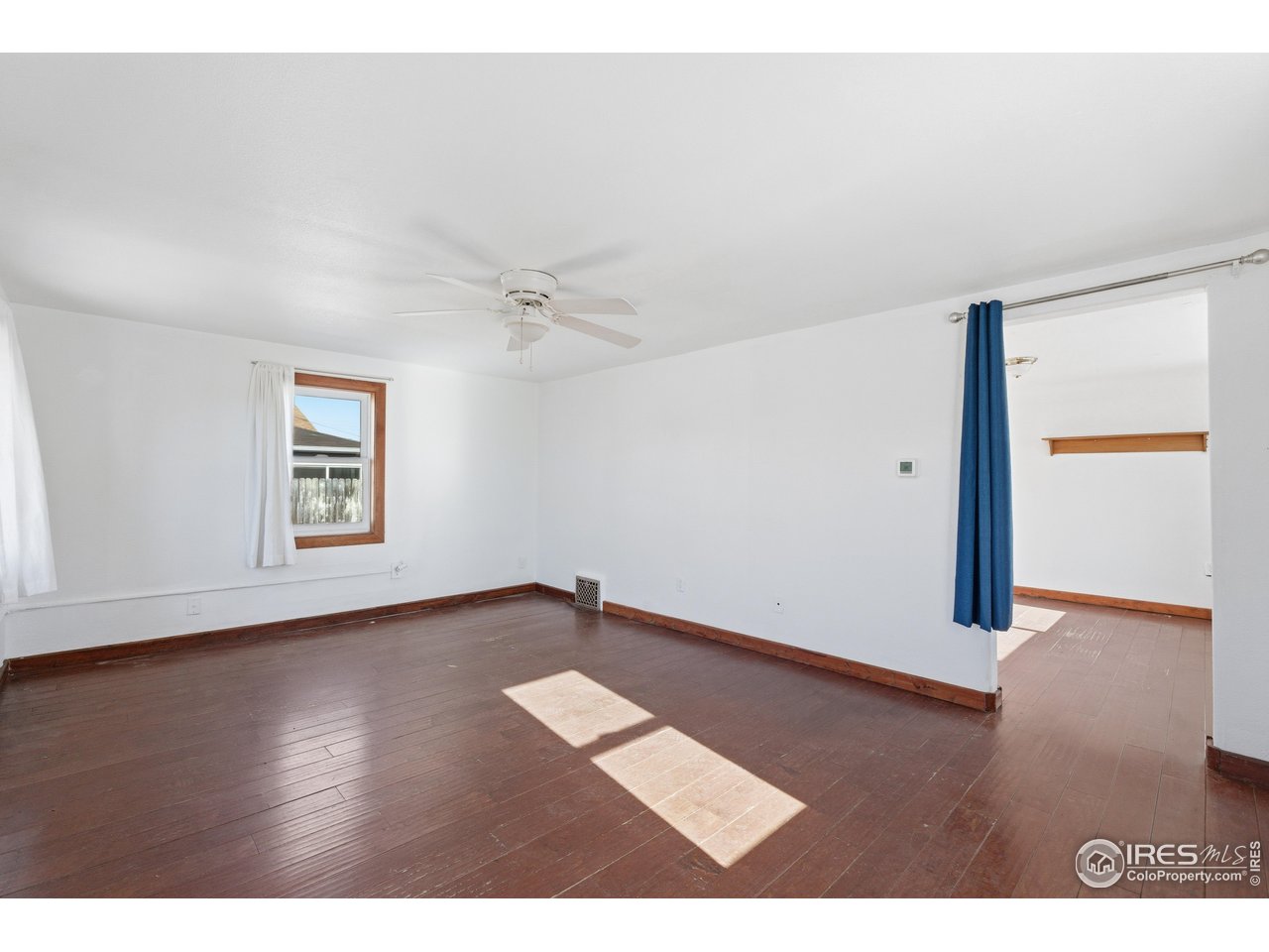 2706 7th Avenue Garden City, CO 80631 - Photo 7 of 47 a view of an empty room with wooden floor