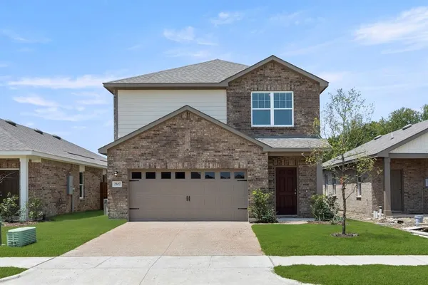 a front view of a house with a yard and garage