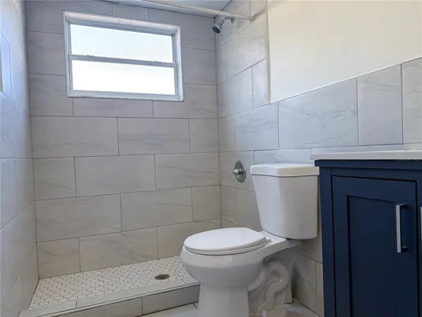 a white toilet sitting next to a bathroom sink