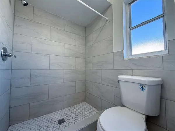 a white toilet sitting next to a bathroom sink