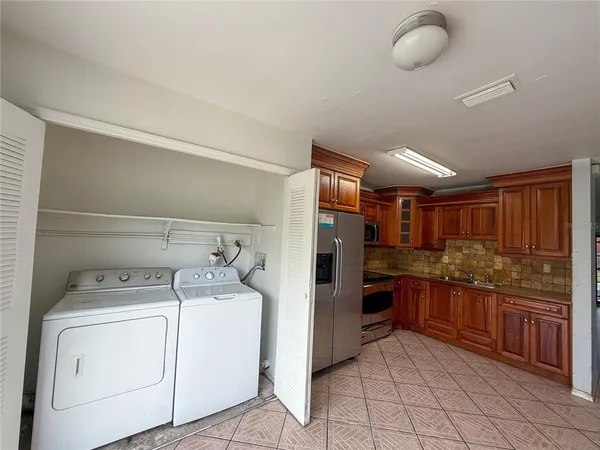 a kitchen with a refrigerator and cabinets