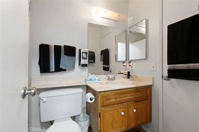 a bathroom with a sink a toilet a mirror and shower