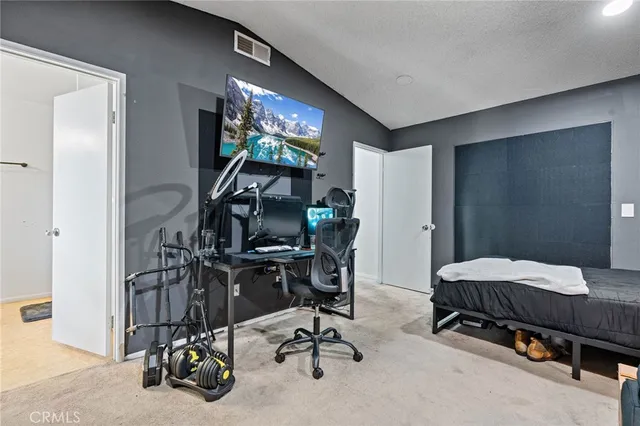 a bedroom with furniture and a gym machine