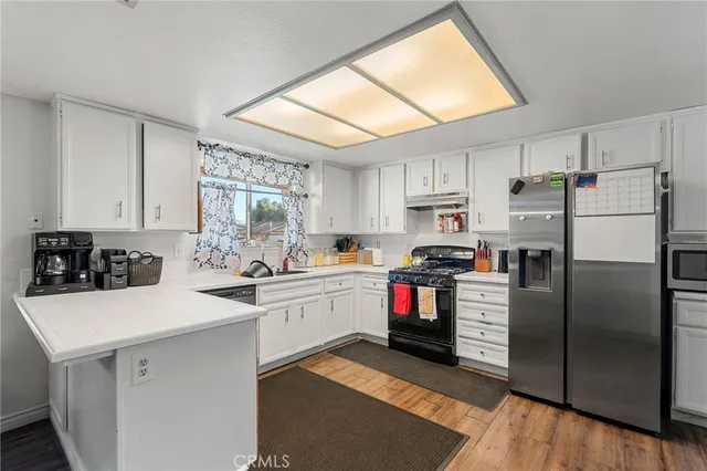 a kitchen with white cabinets and white appliances