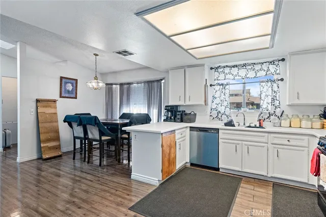 a kitchen with a table chairs sink and cabinets