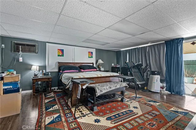 a bed sitting in a spacious bedroom next to a window