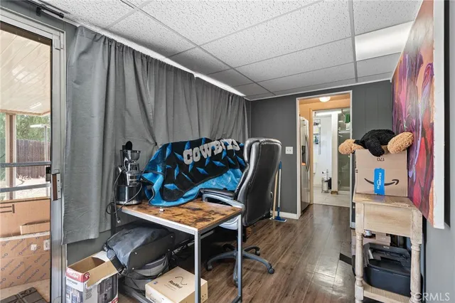 a bedroom with furniture and a wooden floor
