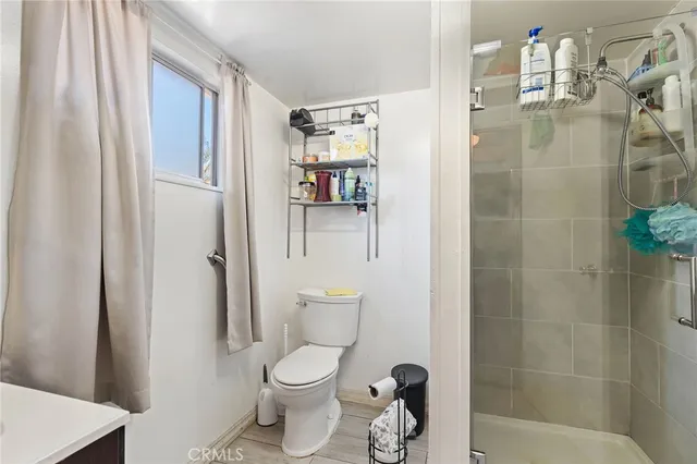 a bathroom with a toilet and a shower