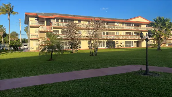 a view of an apartment with a backyard