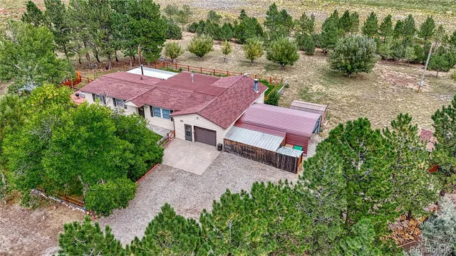 an aerial view of a house with a yard