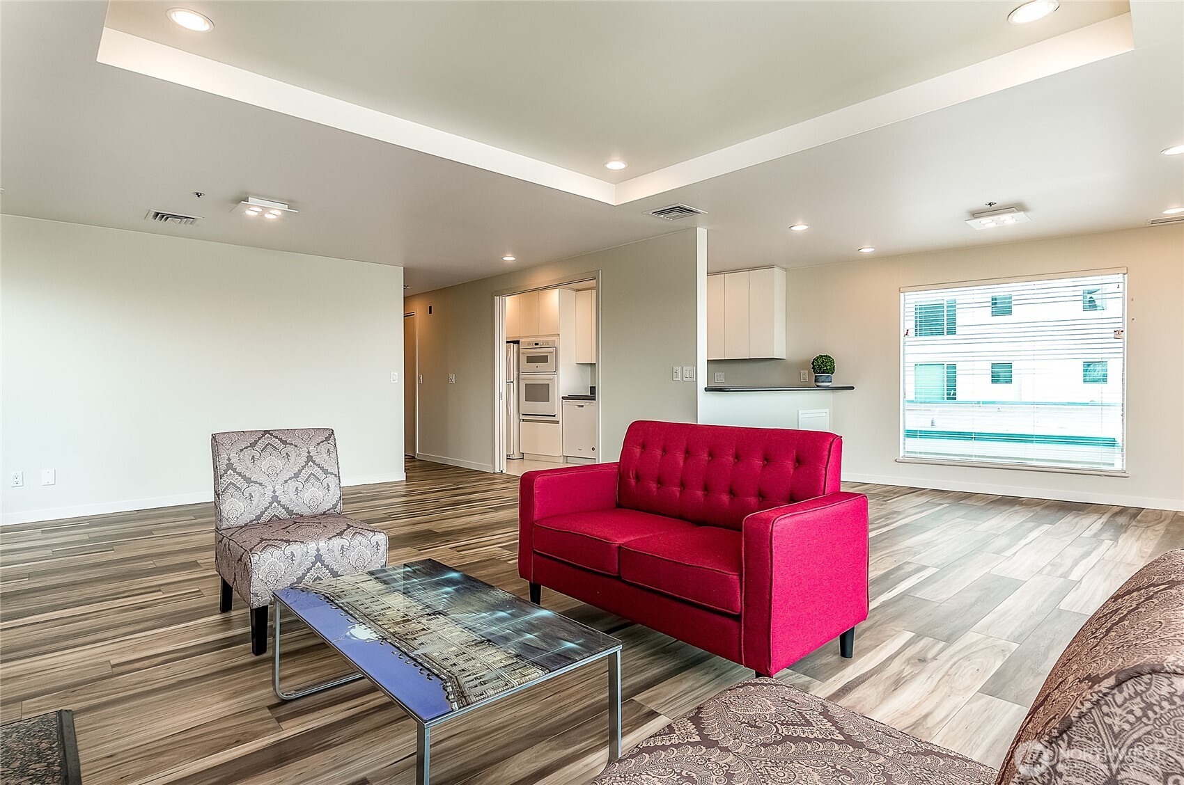 1027 Harbor Avenue Southwest, Unit 303 Seattle, WA 98116 - Photo 12 of 20 a living room with furniture and wooden floor