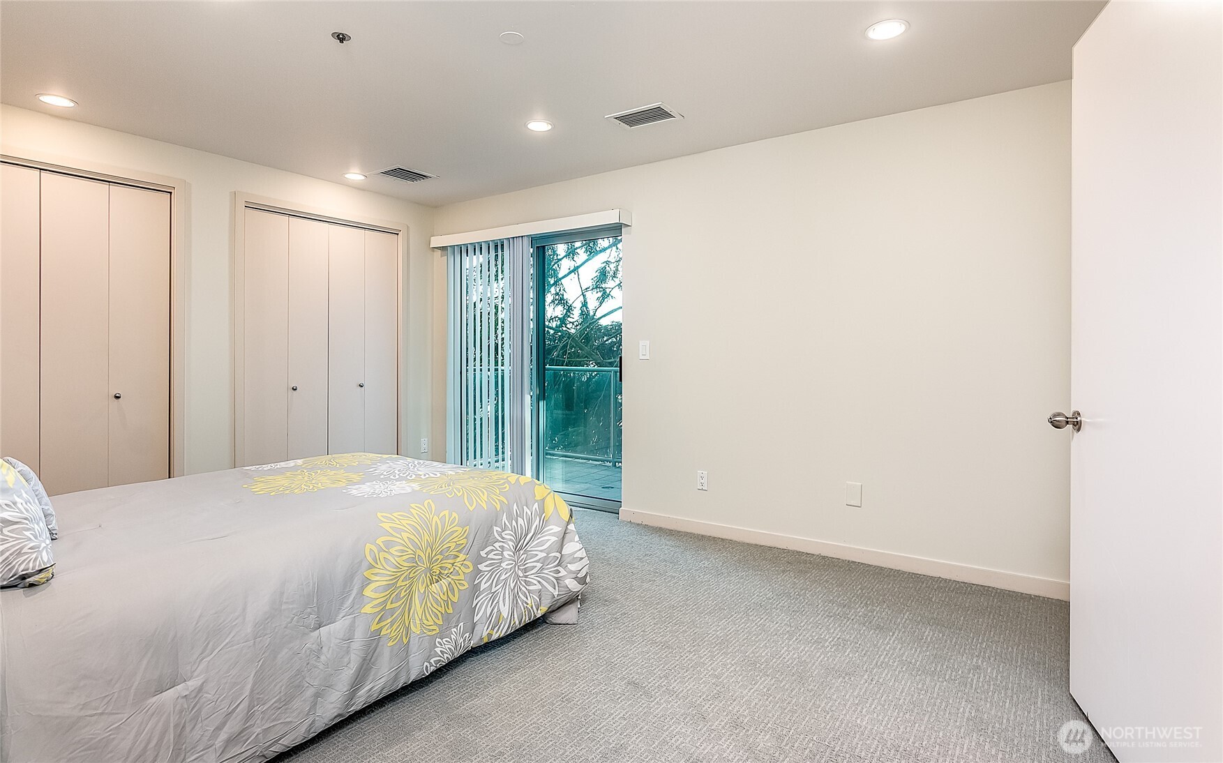 1027 Harbor Avenue Southwest, Unit 303 Seattle, WA 98116 - Photo 15 of 20 a large bed sitting in a spacious bedroom next to a window