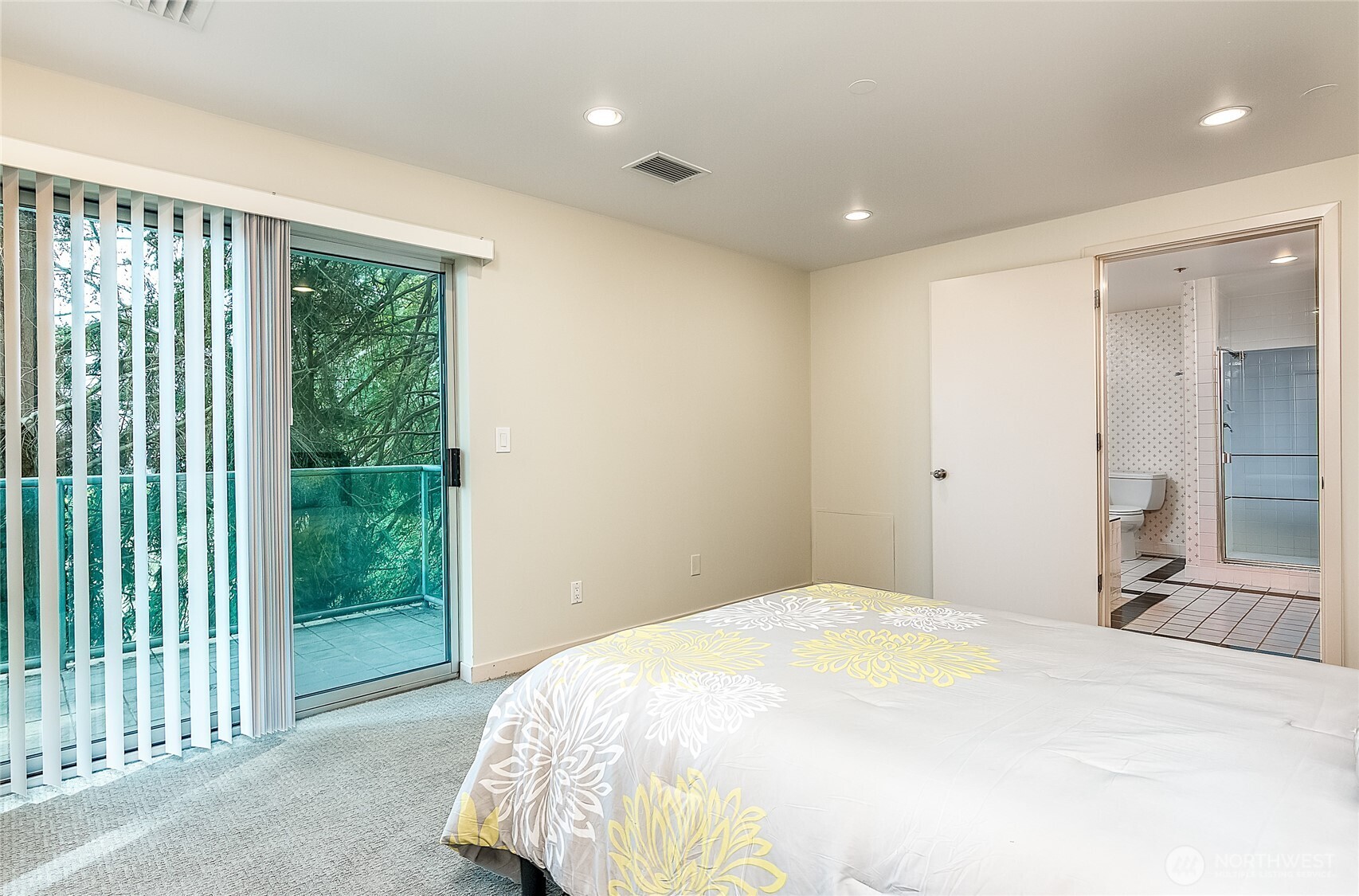 1027 Harbor Avenue Southwest, Unit 303 Seattle, WA 98116 - Photo 16 of 20 a bedroom with a bed and a large window