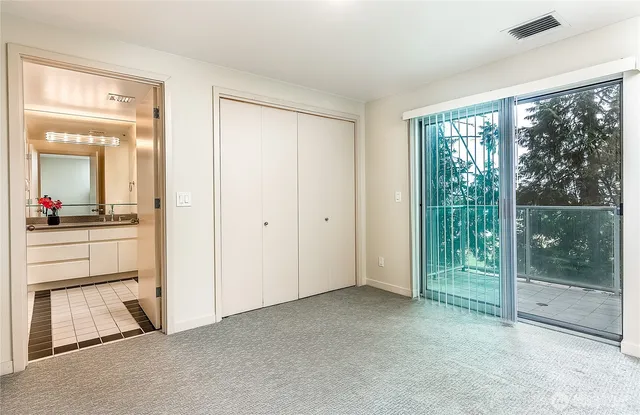 a bathroom with a granite countertop sink a toilet and shower